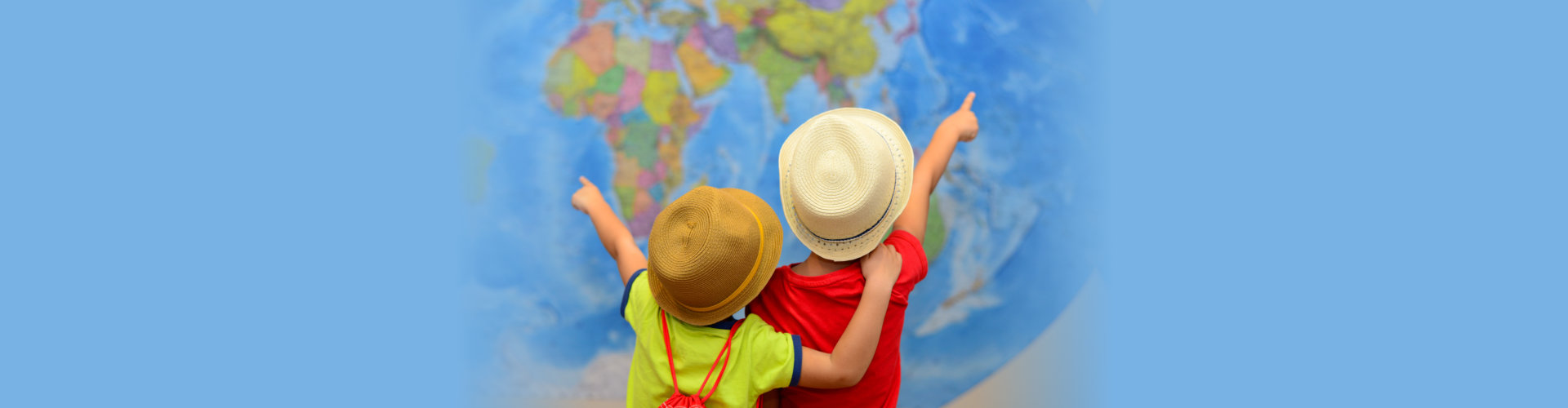 Children pointing in front of a map of the world